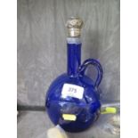 A blue glass claret jug with a white metal collar, as found, with a silver stopper