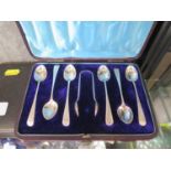 A set of six silver coffee spoons and matching sugar nips