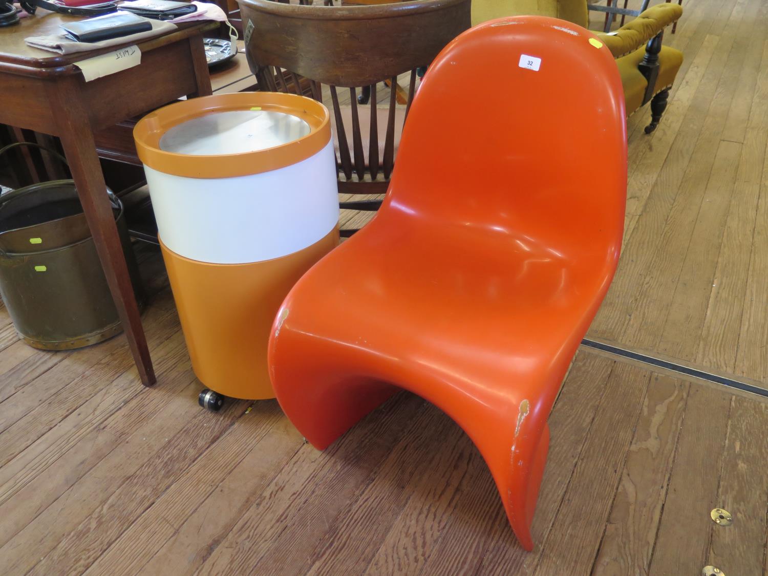 A Vernon Panton style S-shape stacking chair in orange, no maker's marks, and a 1970s orange and