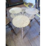 A carved wood Indian table, the top in the form of three lily pads, on a folding carved tripod base,
