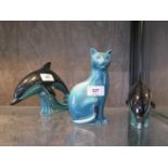 A Poole Pottery figure of a Dolphin, 14 cm high, another 11 cm high and a figure of a cat, 16 cm