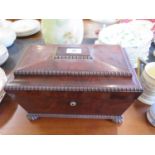 A Regency mahogany sarcophagus form tea caddy, containing original cut glass bowl and two lidded