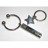 A Tiffany & Co ball and bar silver key ring, and a similar silver star key ring, both marked 925, in