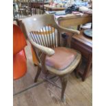 A 1930s spindle backed office chair, on cabriole legs with pad feet and stretchers