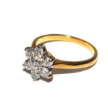 A seven stone diamond ring in the form of a flower set in 18 carat gold