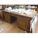 An early 20th century oak partner's desk, one side with three frieze drawers over three drawers in