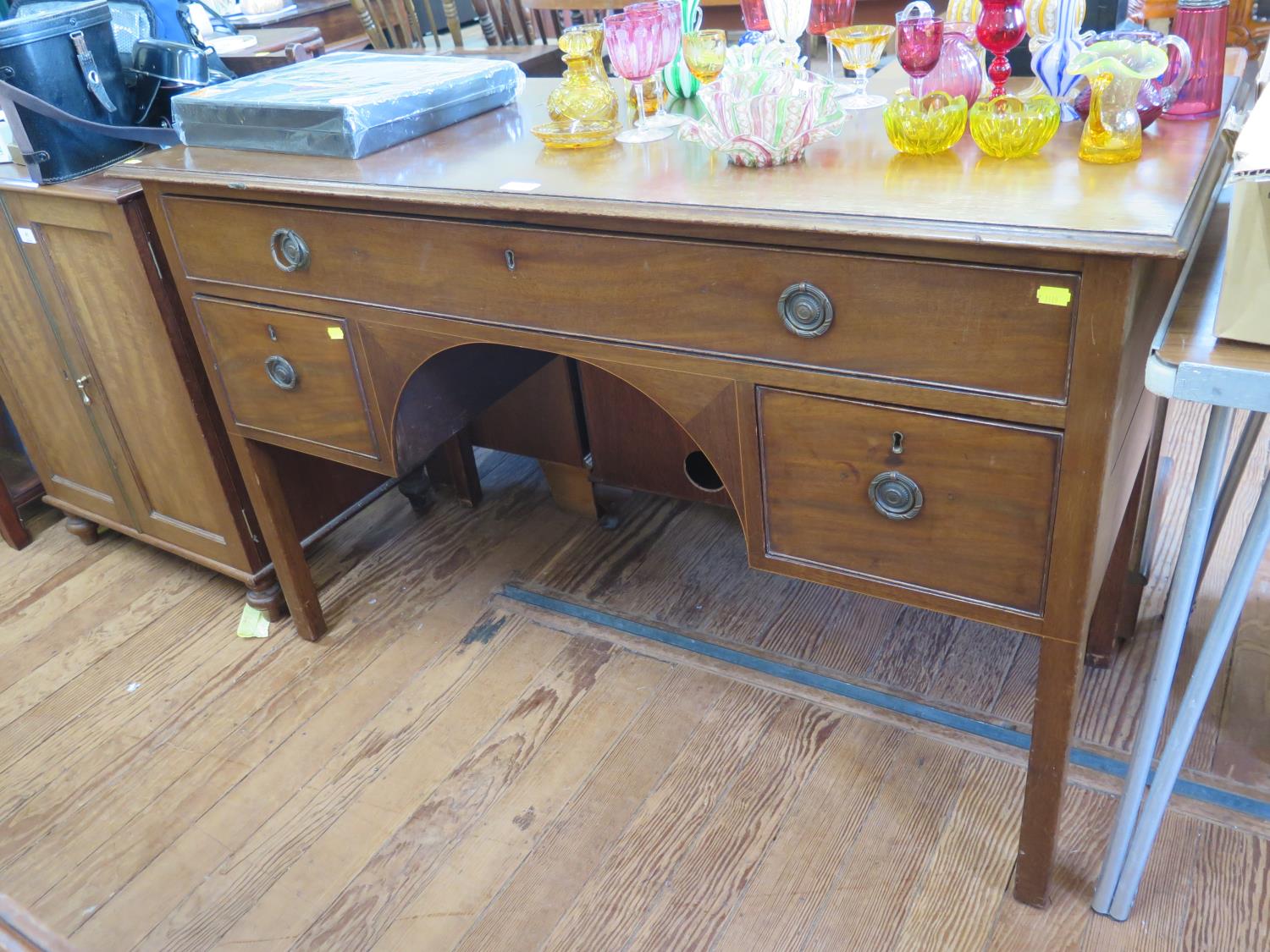 A mahogany dressing table, the long frieze drawer over a kneehole and two deep drawers on square