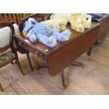 A Regency mahogany Pembroke table, the rectangular top with drop leaves over a single frieze