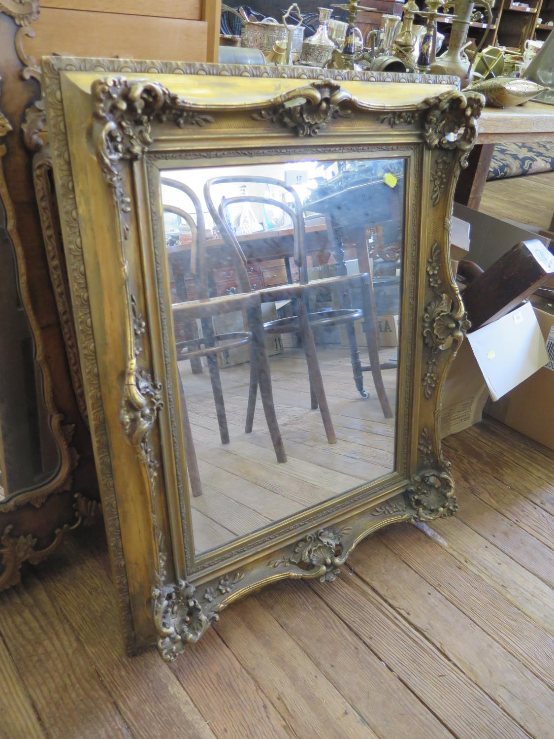 A 19th century style giltwood frame, with applied shell and scroll designs, with a later mirror