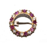Gold coloured metal brooch set with red and white stones