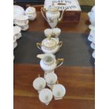 A French porcelain cabinet coffee service, with gilt foliate decoration, with six coffee cans