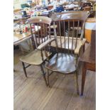 Two ash and elm kitchen armchairs, with spindle backs, moulded seats and ring turned legs, one