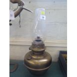 A brass oil lamp and collection of weights