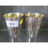 A pair of continental silver beakers with gilded interiors
