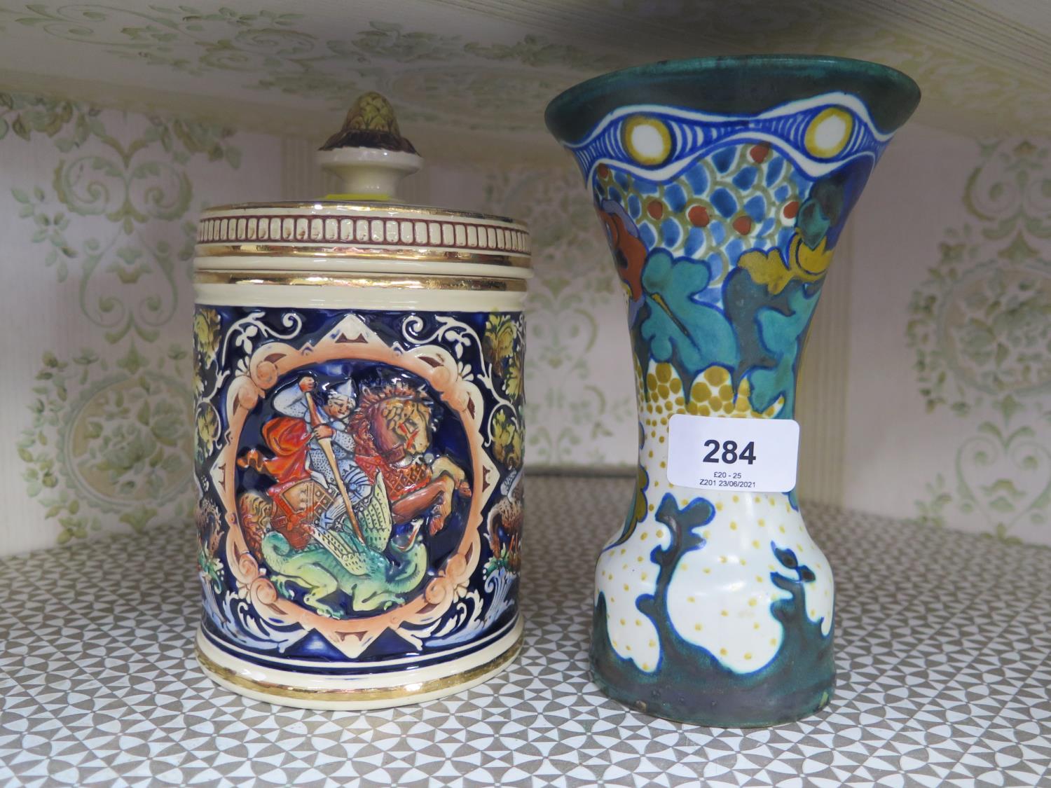 A Gouda Corona pottery vase with hand painted decoration together with a stoneware cookie jar with