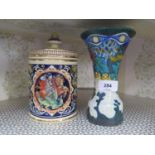 A Gouda Corona pottery vase with hand painted decoration together with a stoneware cookie jar with