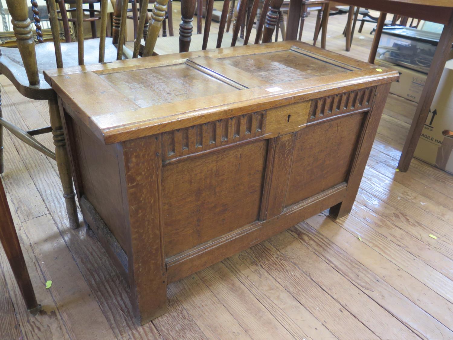 An oak twin panelled coffer, with fluted frieze, 89 cm wide, 49 cm deep, 52 cm high