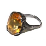 A silver ring set with citrine coloured stone