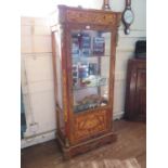 A French style inlaid and gilt-metal mounted display cabinet, the scroll inlaid frieze over a glazed