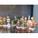 Thirteen Hummel figures by Goebel, including Little Hiker, Latest News, Meditation and others, three