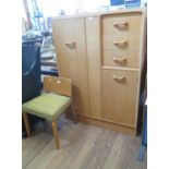 A set of E. Gomme G-Plan oak bedroom furniture, including a low wardrobe with single door, three