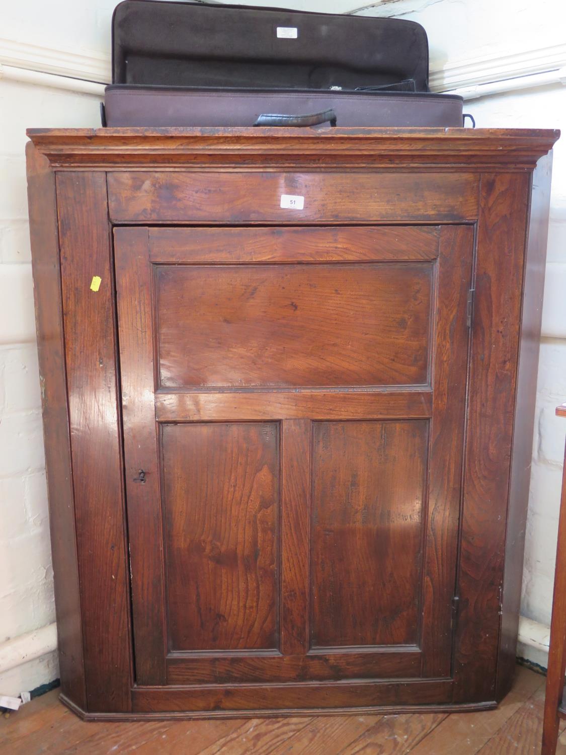 An elm corner cabinet with panelled door, 92 cm wide, 108 cm high