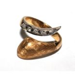 A diamond set snake ring in 18 carat gold