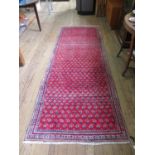 A Persian Sarouk Mir design runner, with allover boteh design on a red ground, 300 x 109 cm