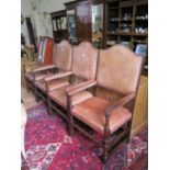 A set of four oak framed large carver dining chairs, with leather upholstered backs, seats and arms,