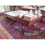 A Regency crossbanded mahogany library table, the rectangular leather inset top over three frieze