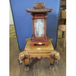 A side table light in the form of a Chinese pagoda, with paper shades, 56 cm high, and an Indian