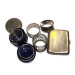A collection of silver collectables to include five napkin rings, a silver cigarette case, a