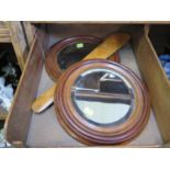 A pair of small circular mahogany wall mirrors, with bevelled plates, 27.5 cm diameter, and a page