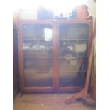 An oak glazed bookcase, the twin doors enclosing adjustable shelves on bracket feet, 125 cm wide,