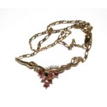 A 9 carat gold pendant set with white and red stones, possibly rubies and diamonds