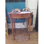 An Edwardian inlaid oval window table, the patera inlaid and crossbanded top over an inlaid