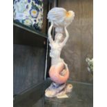 A Unicorn Studio porcelain figure of a mermaid holding a large shell, 24 cm high