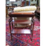 An Edwardian mahogany standing book rack with patera inlay, on outsplayed legs with pot castors,