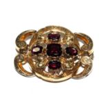 A Victorian brooch set with garnets