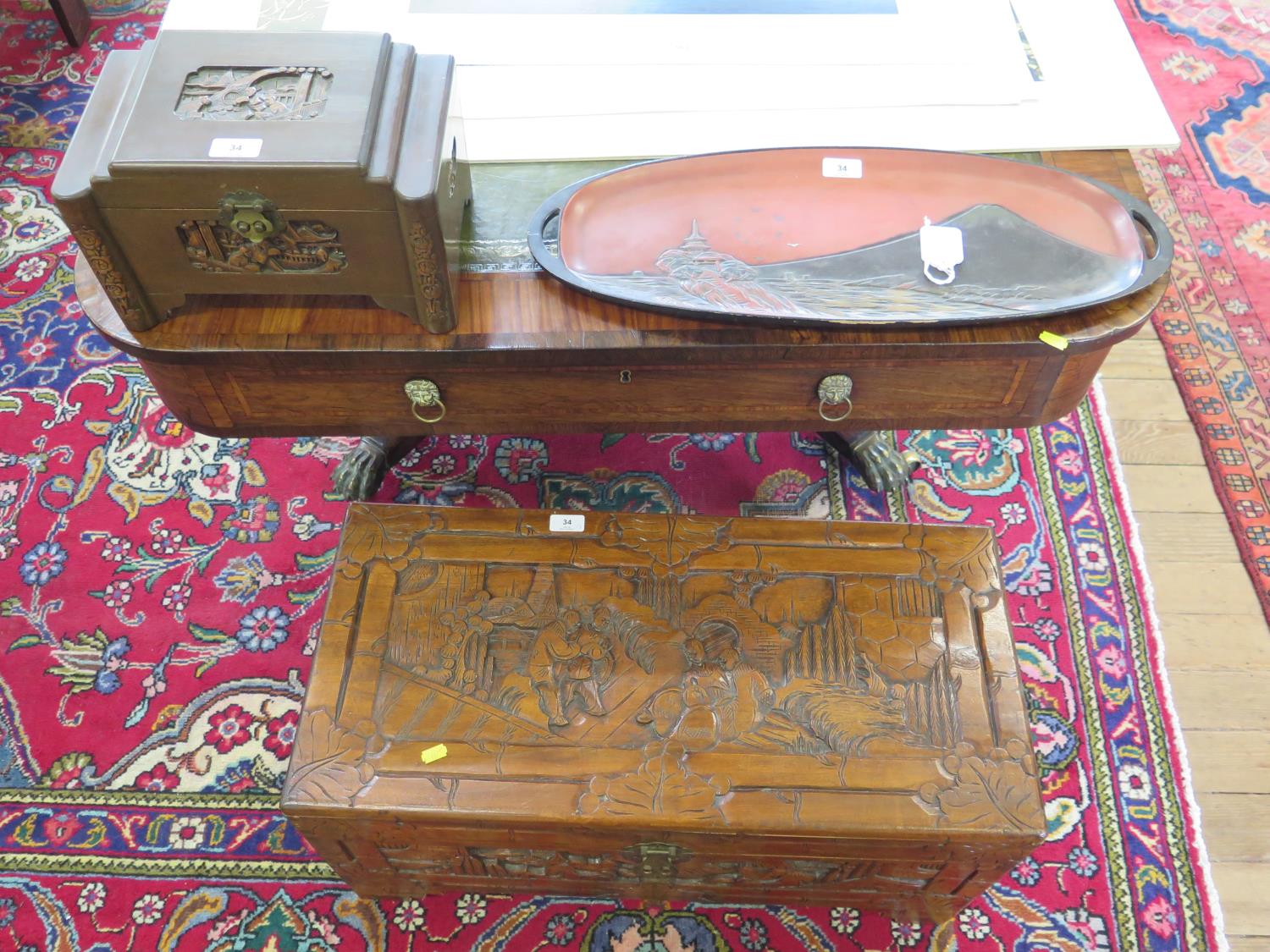 A Chinese carved camphorwood chest, 73 cm wide, 35 cm deep, 38 cm high, a miniature Chinese chest,