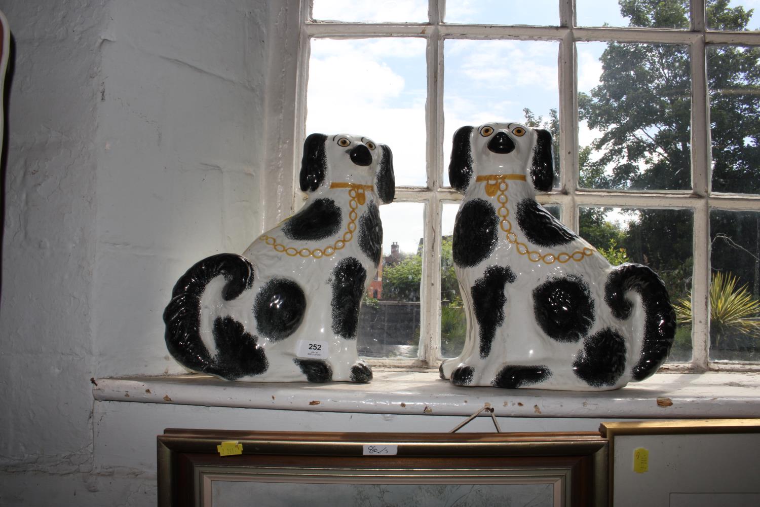 A pair of Victorian black and white Staffordshire dogs, 31.5 cm high