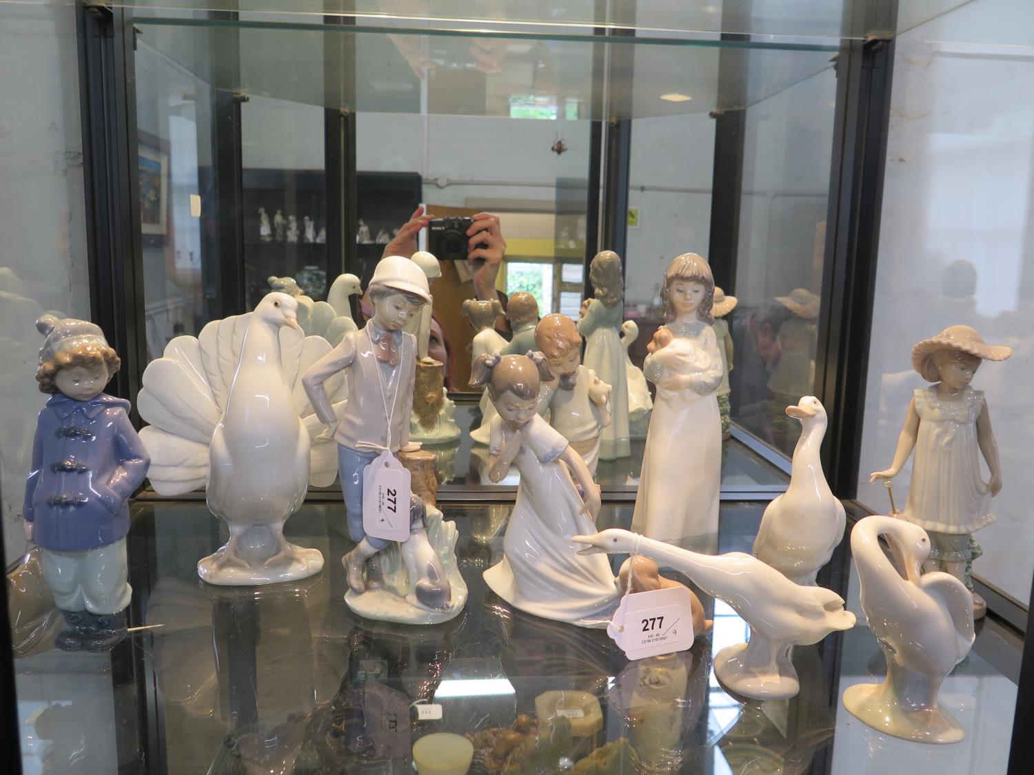 A Lladro figure of a dove, 20 cm high, two Lladro figures of geese, a Nao figure of a goose and
