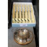 An Arts and Crafts silver plated on copper tea strainer and stand, and six vintage tea knives