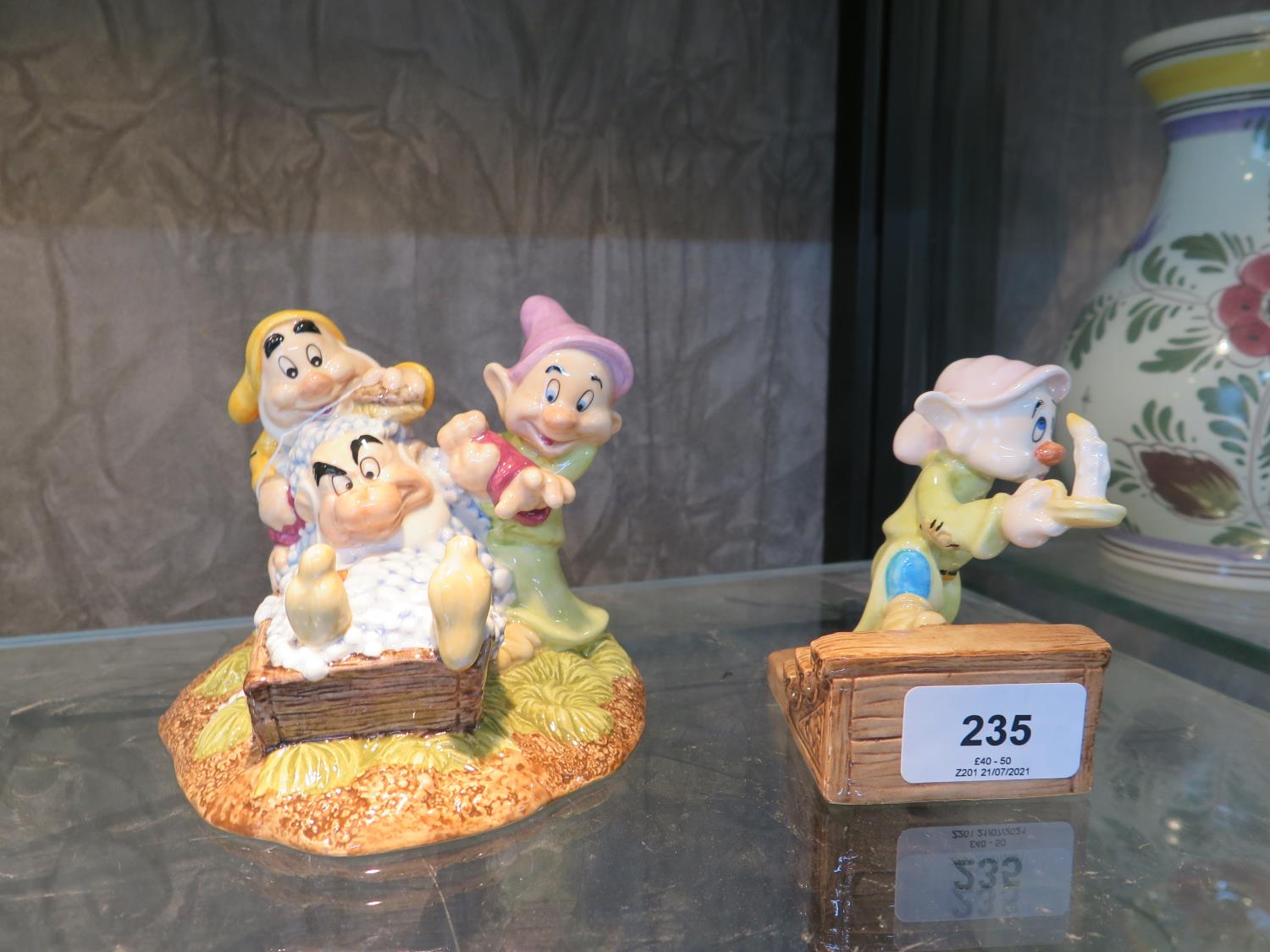 A Royal Doulton Snow White Grumpy's Bath Time together with Dopey by candle light models SN20 and