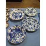 Four blue and white tin glazed chargers, with floral designs, largest 35.5 cm diameter, as found (4)