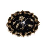 A Victorian mourning brooch, set in black enamel with seed pearl decoration