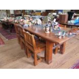 A hardwood dining table and seven dining chairs, in the rustic style, the table top inset with