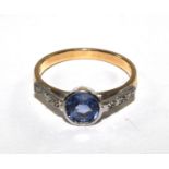An 18 carat gold ring set with central sapphire and diamond shoulders