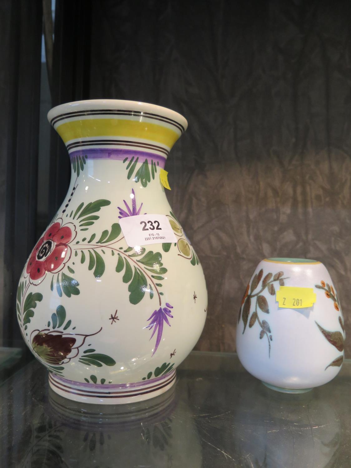 A Delft hand decorated vase with coloured flower decorated, and a small Gouda pottery vase