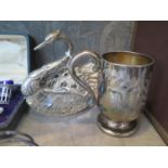 A silver child's christening mug together with a glass and white metal swan, as found